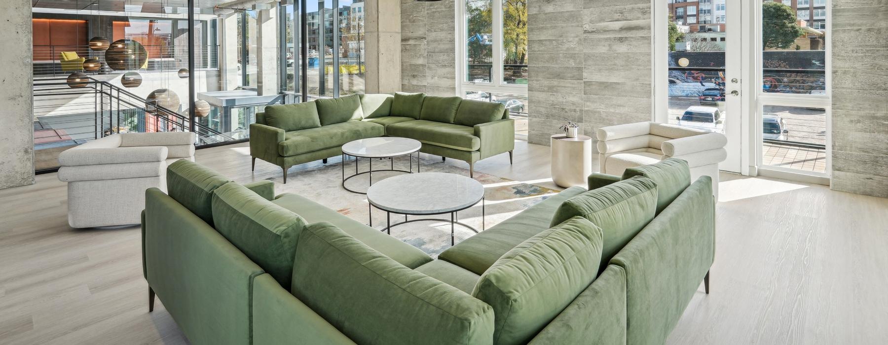 clubroom with a green couch and table with a light above