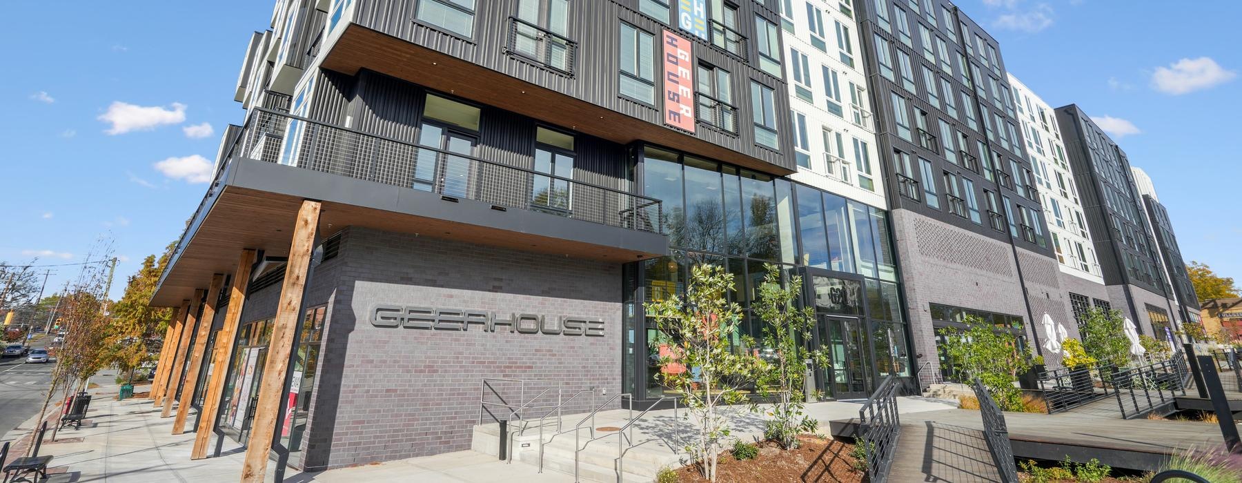 a building with a walkway and plants