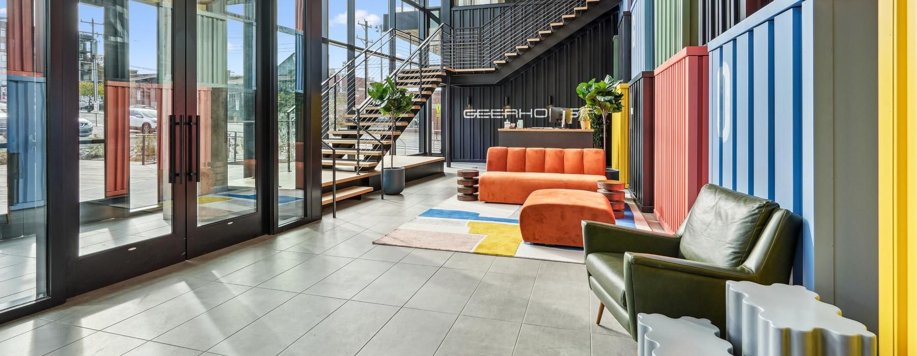 a room with a staircase and chairs